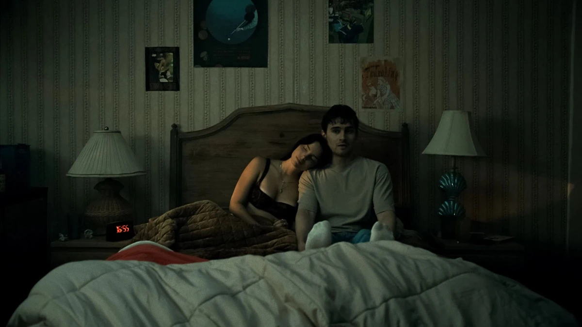 Os atores Michael Johnston e Inde Navarrette sentados na cama em cena do filme Obsessão.